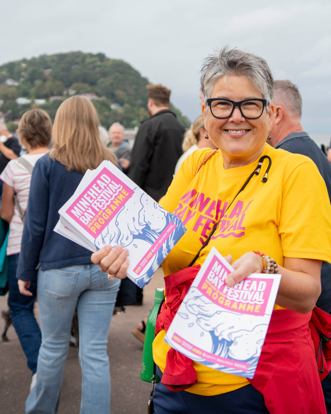 Volunteer giving out leaflets at Minehead Bay Festival